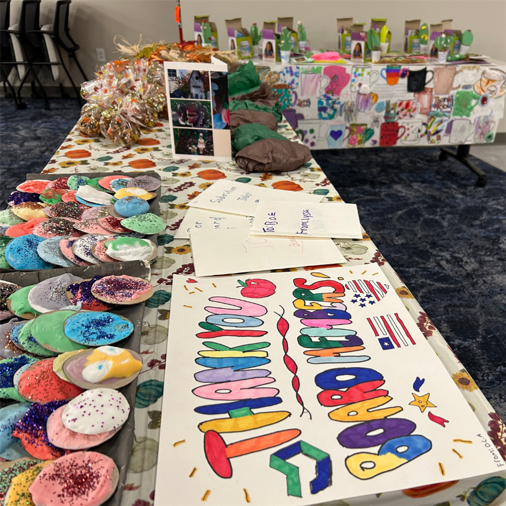  Tables are covered with student-created items for Board Recognition Night. 